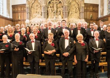 members of the choir in formal dress pose for photo in church